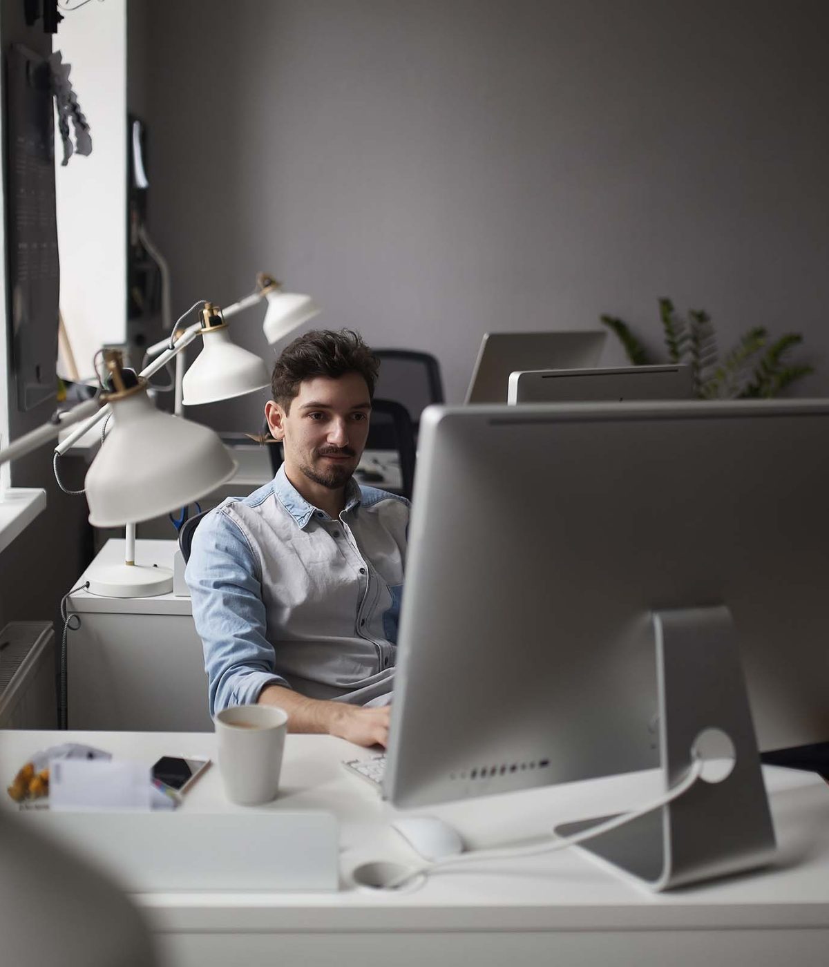 young-intelligent-bearded-man-working-at-modern-lo-ZMWRQLS.jpg